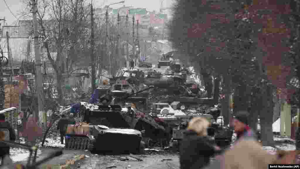 Ukraine -- People look at the gutted remains of Russian military vehicles