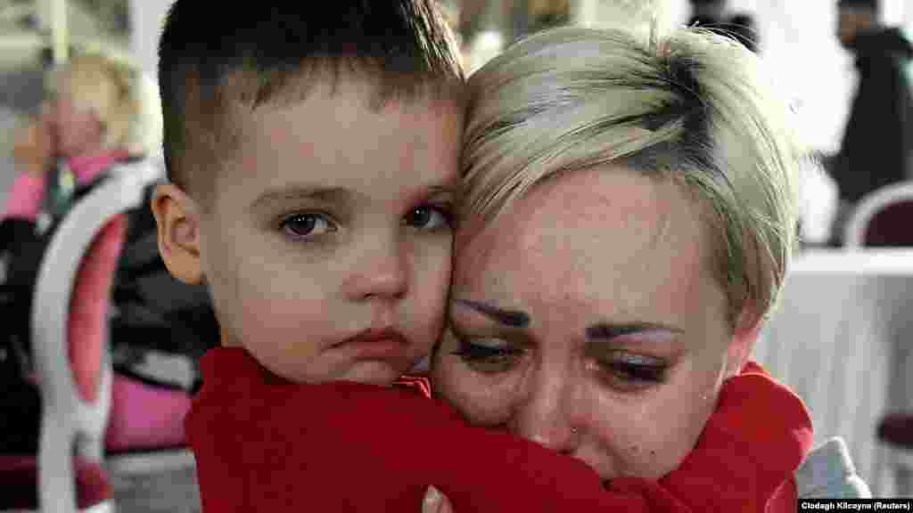 Ukraine -- Egor, 5, comforts his mother Helen Yakubets