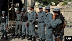 Afghanistan -- Afghan policemen inspect the site of a suicide attack in Kabul on 25May2013.