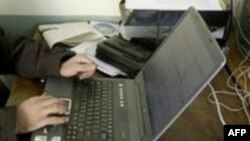 Afghanistan -- Hafizullah Ghushtili, Afghan journalist, in his office in Kabul, 9 Nov. 2004