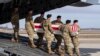 FILE - In this Dec. 25, 2019, file photo, an Army carry team moves a transfer case containing the remains of U.S. Army Sgt. 1st Class Michael Goble, at Dover Air Force Base, Del.. Goble, a U.S. Special Forces soldier who died in Afghanistan this week, was