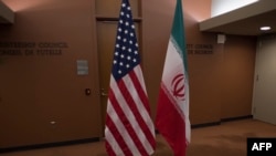 U.S. -- The US (L) and Iranian flags await the arrival of US Secretary of State and Iranian Foreign Minister before their meeting at the United Nations in New York, April 19, 2016